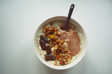 bowl of oat porridge with muesli and chocolate