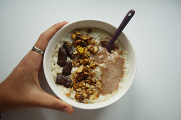 bowl of oat porridge with muesli and chocolate