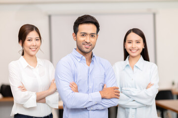 Asian indian business men leader standing smile cross arm with team