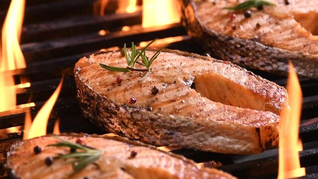 Slow motion : Grilled salmon on the flaming grill