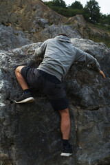 young man climbing in the rock