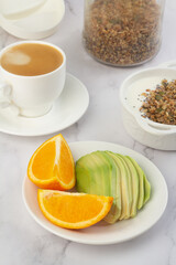 breakfast of coffee, porridge and avocado on a white background.