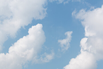white cloud with blue sky sunlight from left