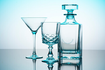 Cups and licour bottle with blue and white background