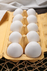 Box with chicken eggs on wooden background