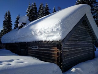 Snow-covered old beam house, Norway