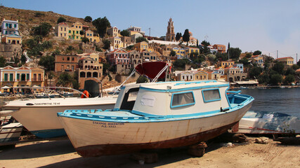 Fototapeta na wymiar Fishing boats in the port of Symi town, Symi island, Greece