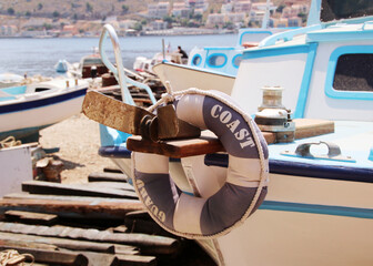 
Lifebuoy ring hanging on the bow of a coast guard boat in a dock, Symi island, Greece
