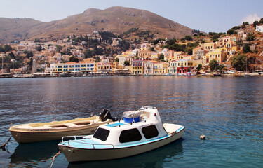 Fototapeta na wymiar Fishing boats in the port of Symi town, Symi island, Greece