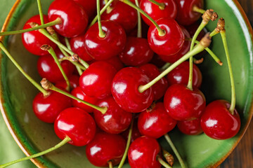 Ripe sweet cherry in bowl, closeup