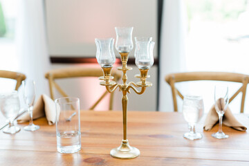 Candle holder on table with water and glasses