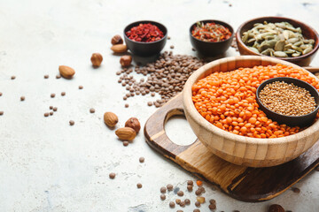 Bowls with lentils and spices on white background
