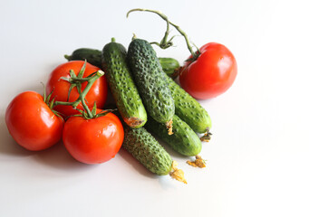cucumbers and tomatoes on a white background close up