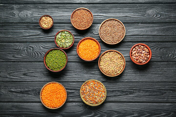 Bowls with raw legumes on table
