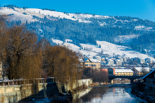 Dorna River covered with snow on the edge, Vatra Dornei, Romania