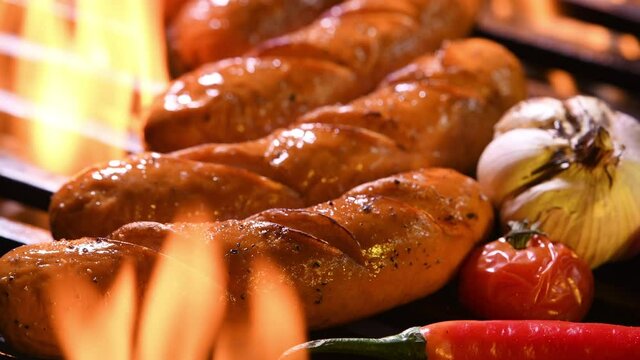 Grilled sausages on the flaming grill