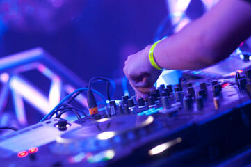 Naklejka na ściany i meble DJs hands on audio system mixing music in a party 