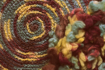 Fluffy multi-colored yarn crocheted on a round plastic canvas close-up. Two parts for the handmade bag. Retro style toned. Top view