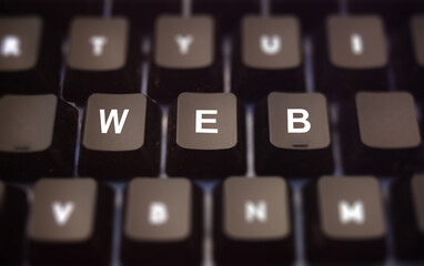 World Wide Web concept. Web text written on keypad. Black keys with white letters message of internet servers on pc keyboard. Blur buttons background.
