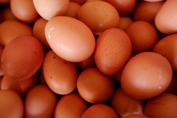 Close-up of fresh chicken eggs (telur ayam) in a basket © Andang Riana