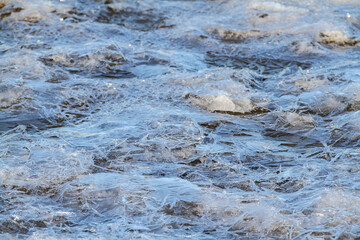 Frozen water ice textures with sun light reflections shoot from low level