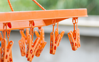 Orange color plastic clothespins on the hangers, clothespins on the hangers for wash clothes.