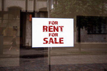 FOR RENT FOR SALE. Shop window with advertising notice