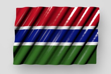 Fototapeta na wymiar beautiful glossy flag of Gambia with big folds lie isolated on grey - any celebration flag 3d illustration..