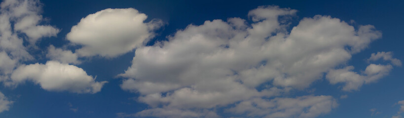 Obraz premium Beautiful blue skies with white fluffy clouds in the daytime. Panoramic view.