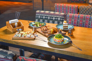 Delicious dinner in restaurant. Served dinner. German Thuringer sausage or bratwurst. Avocado salad with lemon.