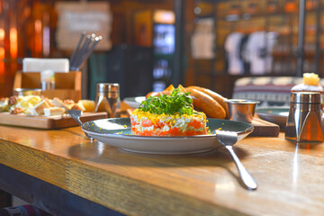 Delicious dinner in restaurant. Served dinner. German Thuringer sausage or bratwurst. Avocado salad with lemon.