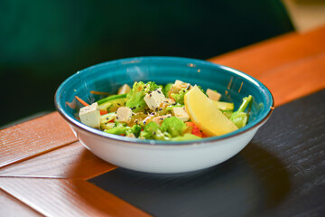 Classic vegetable salad from tomatoes, cucumbers, lemon, red pepper, onion, brocolli, oregano and feta cheese.