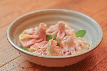 Sweet khinkali with cherry served on a wooden table. Traditional Georgian desserts. Georgian cuisine.