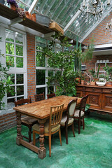 Interior dining design and decoration of coffee cafe, bakery shop and fusion restaurant decorated with wooden furniture, flower plants and sculpture