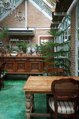 Interior dining design and decoration of coffee cafe, bakery shop and fusion restaurant decorated with wooden furniture, flower plants and sculpture