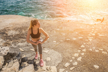 Woman running training on the coastline under sunlight in sunny day