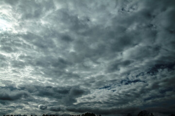 Picturesque clouds in the sky. Window view of an airplane on a sunny gloomy day. Stock photo...