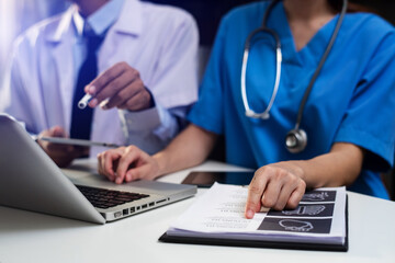 Fototapeta premium Medicine doctor hand working with modern computer and smart phone,digital tablet with his team on white desk as medical concept in morning light 