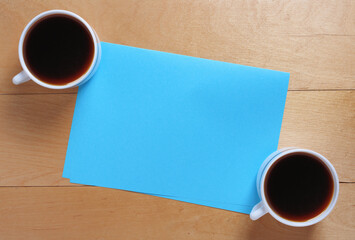 Obraz na płótnie Canvas Two coffee and blue paper