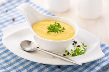 Hollandaise sauce. Classic French cuisine sauce. Emulsion sauce of butter and egg yolks with...