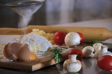 Ingredients for making pizza. Flour on the table.