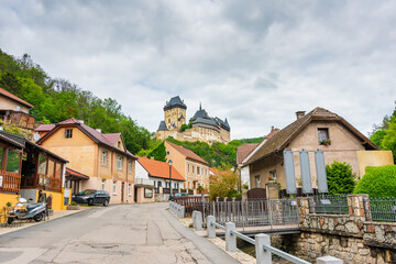 Fototapeta na wymiar Main street leading to the famous gothic castle Karlstejn. Streed shops on the side. Beautiful medieval castle is built by king and emperor Charles IV. Historic heritage of Czech republic.