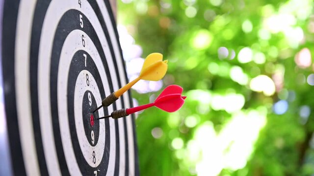 Play dart board game in the garden. Workout and activity at home. Business success and goal.