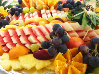 Naklejka na ściany i meble Background of fresh sliced fruit. Fruit at the buffet.