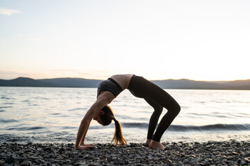 woman doing yoga on the lake