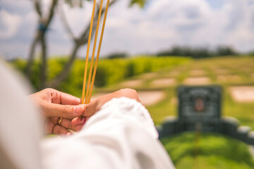 close-up of a woman hand holding incense. Concept of spiritual and religious