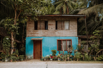 Fototapeta na wymiar small colorful house in the philippines attached to the road