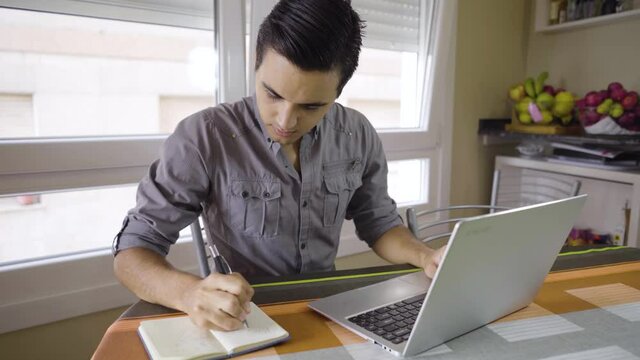 young boy working on laptop from home
