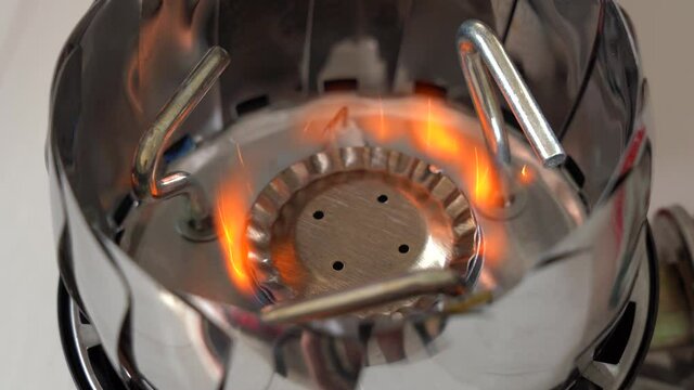 Closeup view 4k video footage of portable modern gas burner and blue flame.