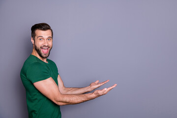Profile photo of attractive amazed handsome guy good mood raise arms side empty space showing...
